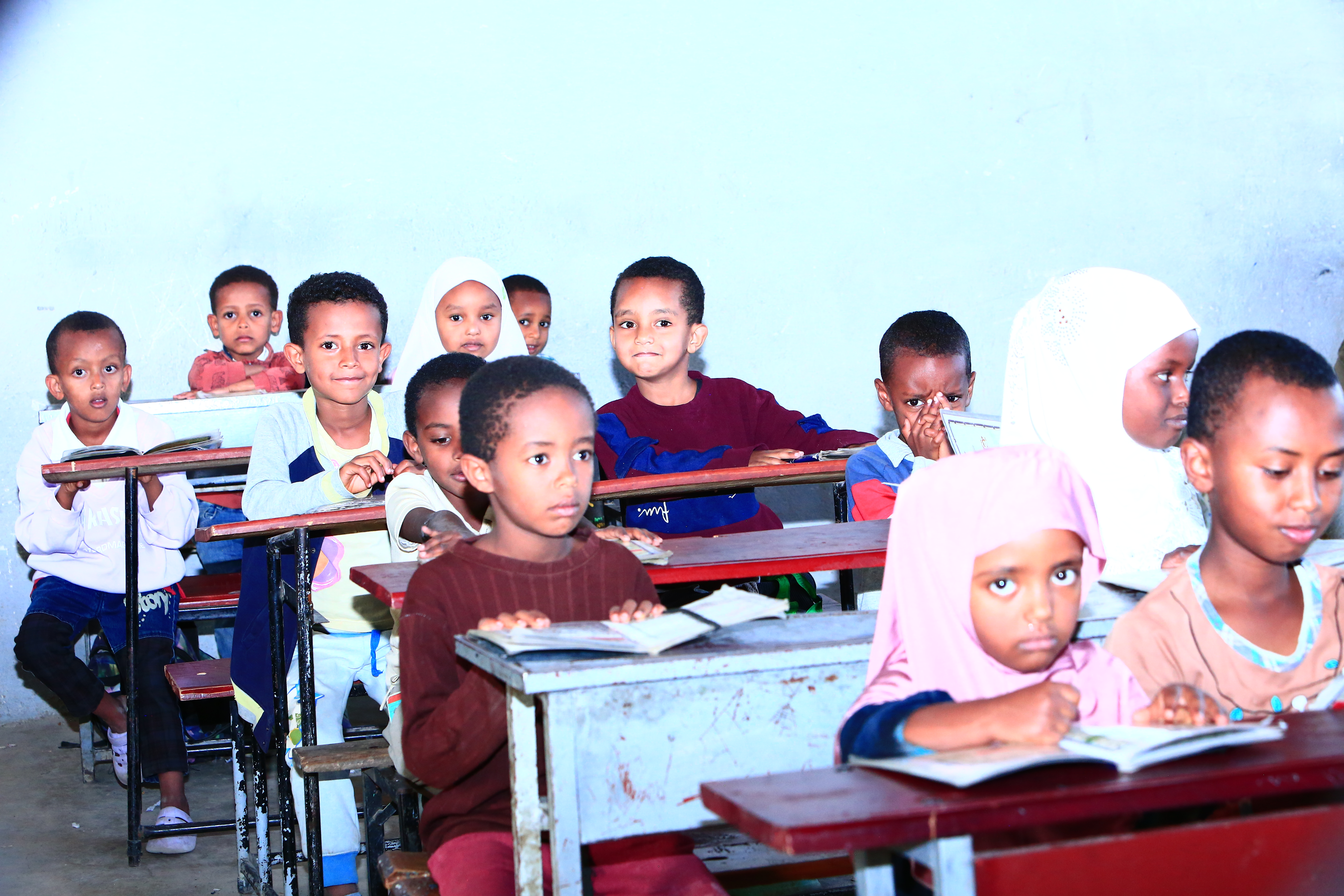 Students learning Quran in a classroom