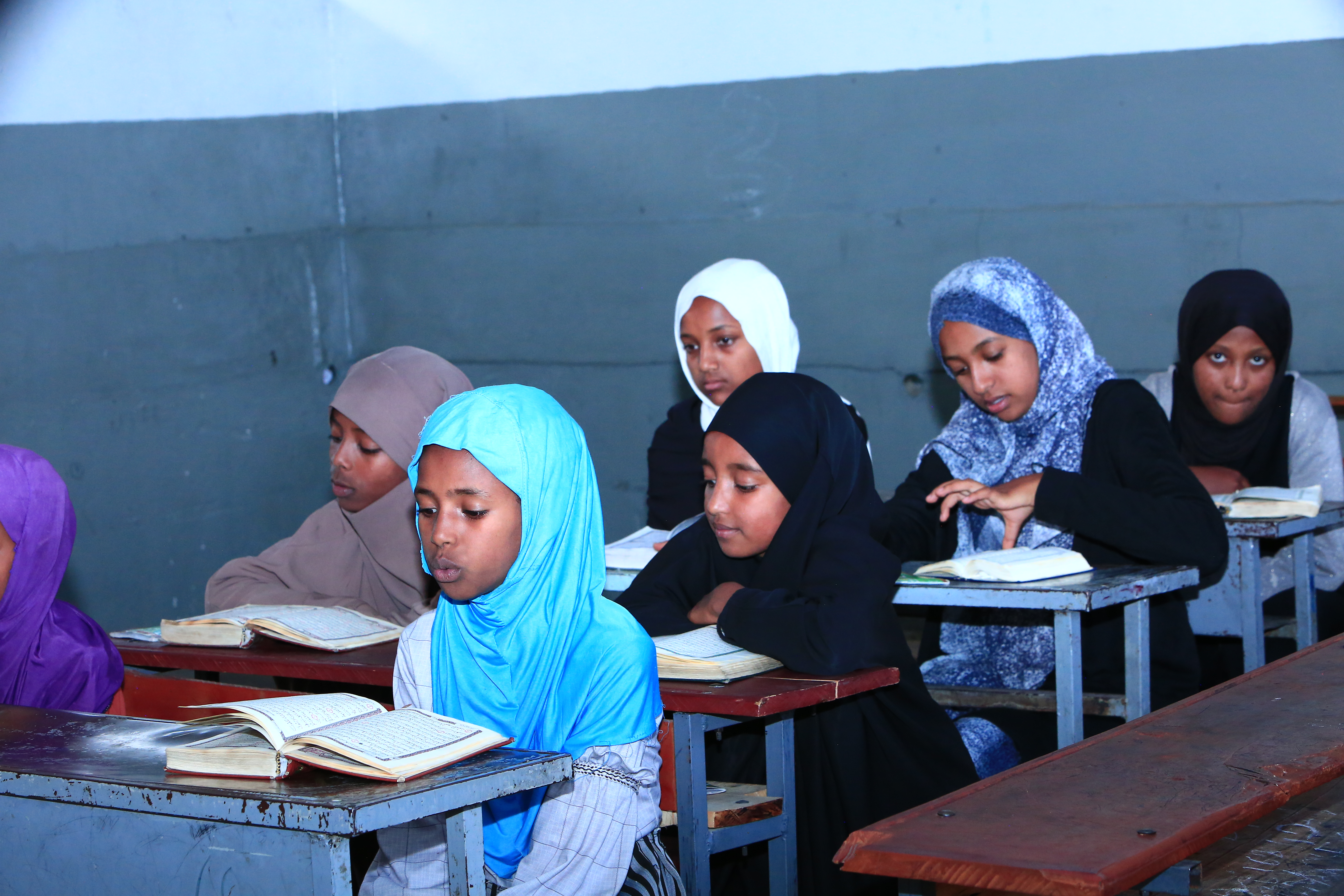 Students learning Quran in a classroom
